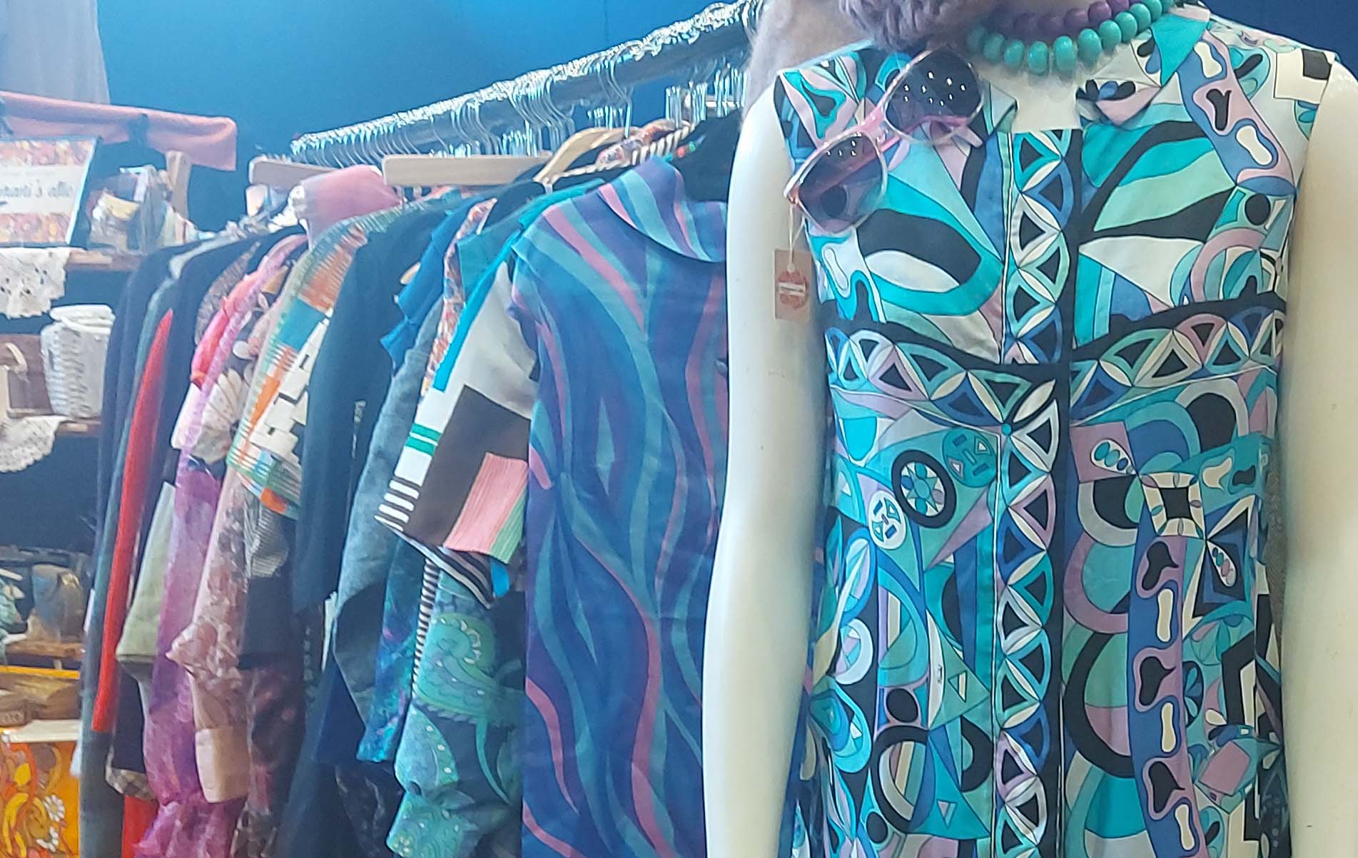 Various vintage clothes hanging on a rack at a clothes fair